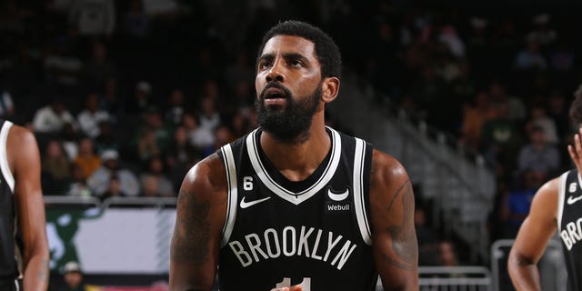 Kyrie Irving #11 of the Brooklyn Nets shoots a free throw during the game against the Milwaukee Bucks on October 12, 2022, at the Fiserv Forum Center in Milwaukee, Wisconsin. 