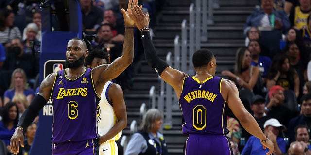 LeBron James #6 of the Los Angeles Lakers high-fives Russell Westbrook #0 during the 1st half of the game against the Golden State Warriors at Chase Center on Oct. 18, 2022 in San Francisco, California.