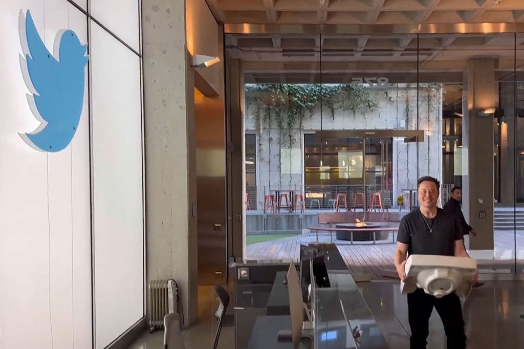 Elon Musk holding a sink at Twitter headquarters