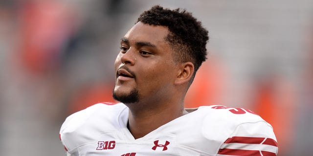 Wisconsin Badgers offensive lineman Logan Brown (50) walks off the field at the conclusion of the Big Ten conference college football game between the Wisconsin Badgers and the Illinois Fighting Illini on October 9, 2021, at Memorial Stadium in Champaign, Illinois.