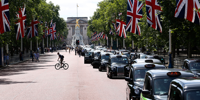 Taxi drivers join a demonstration along the Mall in central London on June 11, 2014.