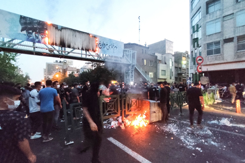 Demonstrators burn a rubbish bin in Tehran, Iran on Sept. 21, 2022.