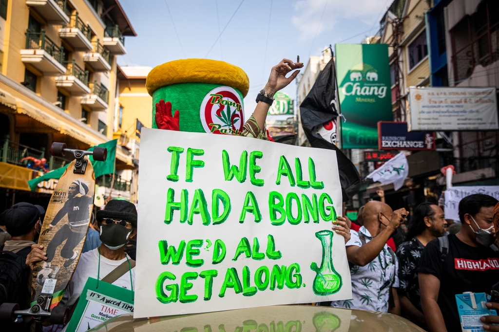 A sign that reads "if we all had a bong we'd all get along" is seen on display at a pro marijuana march on April 20, 2022 in Bangkok, Thailand