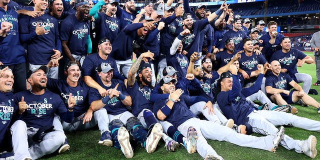 The Seattle Mariners celebrate after defeating the Toronto Blue Jays in Game 2 to sweep the American League wild-card series at Rogers Centre on Oct. 8, 2022, in Toronto.