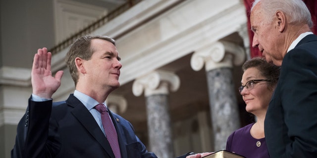 Sen. Michael Bennet is administered an oath by them-Vice President Joe Biden.