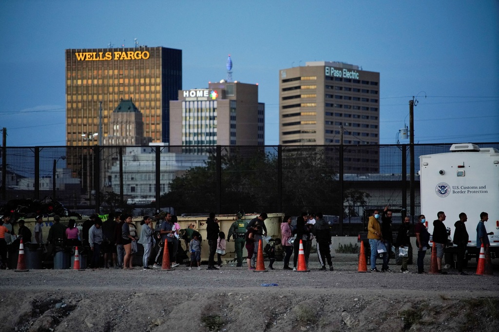 A picture of migrants waiting in line to be processed by U.S. Border Patrol after crossing the border to El Paso.