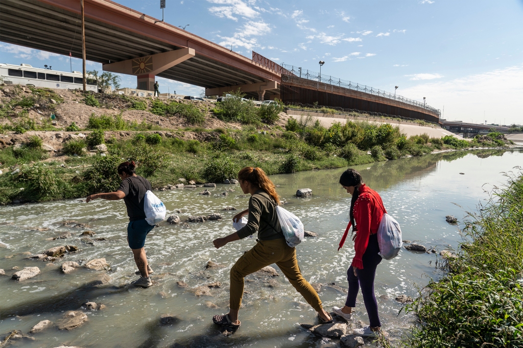 Asylum-seeking migrants from Venezuela crossing the Rio Grande river to enter the US again on October 15, 2022 after previously being expelled.