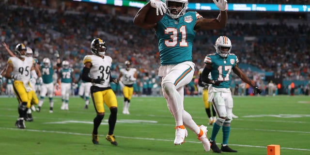 Raheem Mostert #31 of the Miami Dolphins scores a touchdown during the first quarter against the Pittsburgh Steelers at Hard Rock Stadium on October 23, 2022, in Miami Gardens, Florida. 