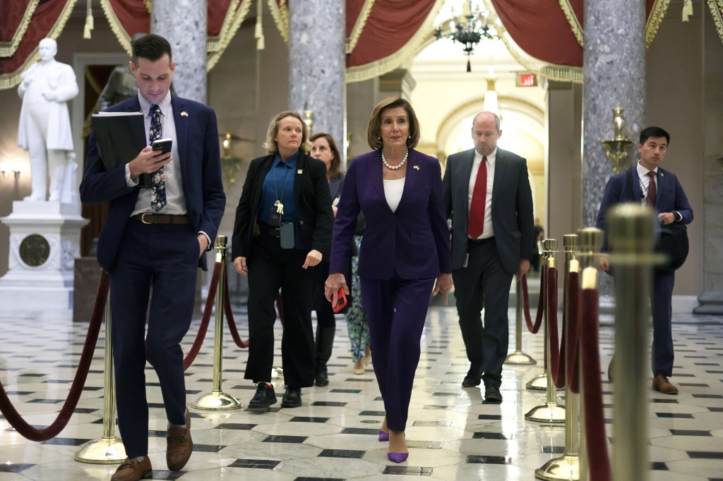 House Speaker Nancpy Pelosi walks back to her office after voting on President Biden’s stopgap funding bill.