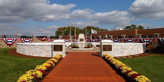 FILE - Flags at the Fallen Firefighters Memorial in Maryland are lowered to half-staff in honor of Dalhart firefighters killed in the line of duty.