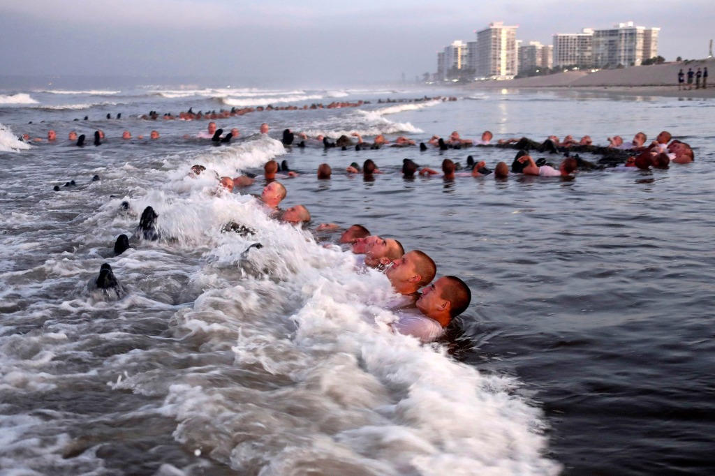 US Navy SEAL candidates, participate in "surf immersion" during Basic Underwater Demolition/SEAL (BUD/S) training at the Naval Special Warfare (NSW) Center in Coronado, California. 