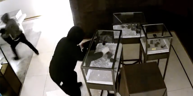 The suspects smashed display cases and stole watches and other jewelry. 