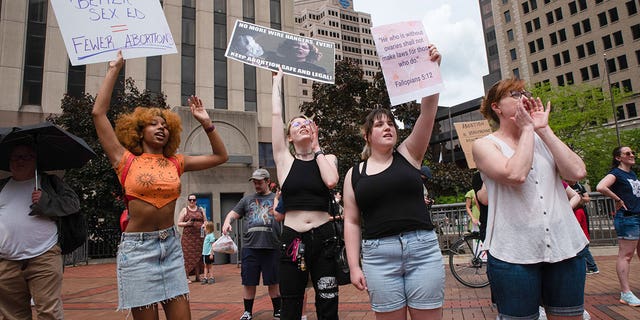 Protesters hold placards expressing their opinion at a pro abortion rights rally. People from many different cities gathered to support and rally for abortion rights.