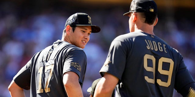 American League All-Stars Aaron Judge, right, and Shohei Ohtani line up before the All-Star Game at Dodger Stadium on July 19, 2022, in Los Angeles.