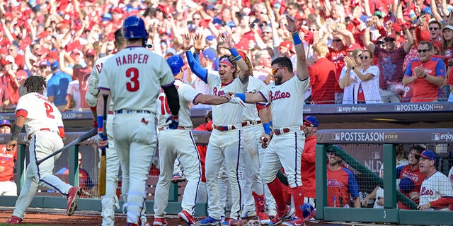 J.T. Realmuto (10) of the Philadelphia Phillies celebrates with teammates after hitting an inside-the-park home run in the third inning during a game against the Atlanta Braves at Citizens Bank Park Saturday, Oct. 15, 2022, in Philadelphia.