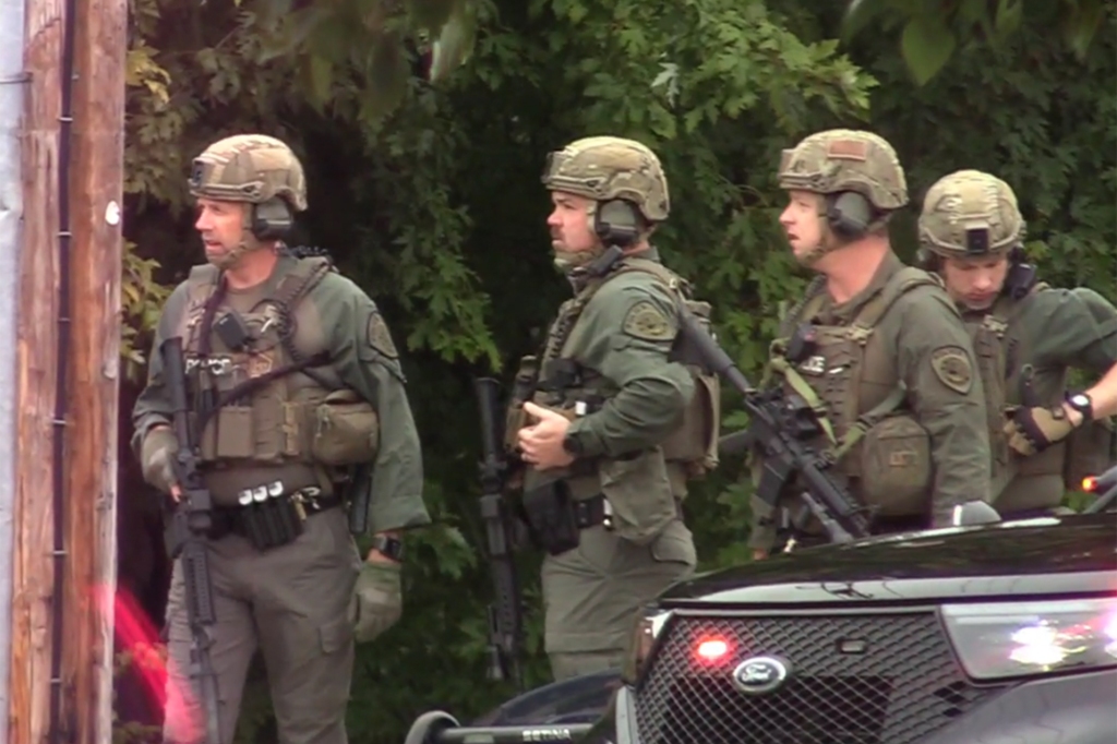 Heavily armed police officers are seen responding to a shooting at the Courtyard Marriott Hotel in Poughkeepsie Sunday, Oct. 2.