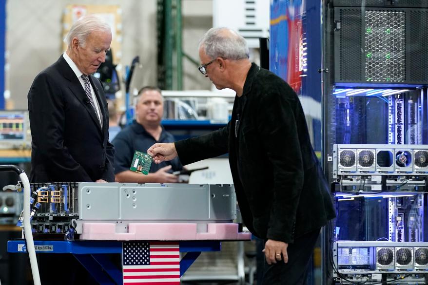 The president inspecting IBM chip, mainframes and memory cards.