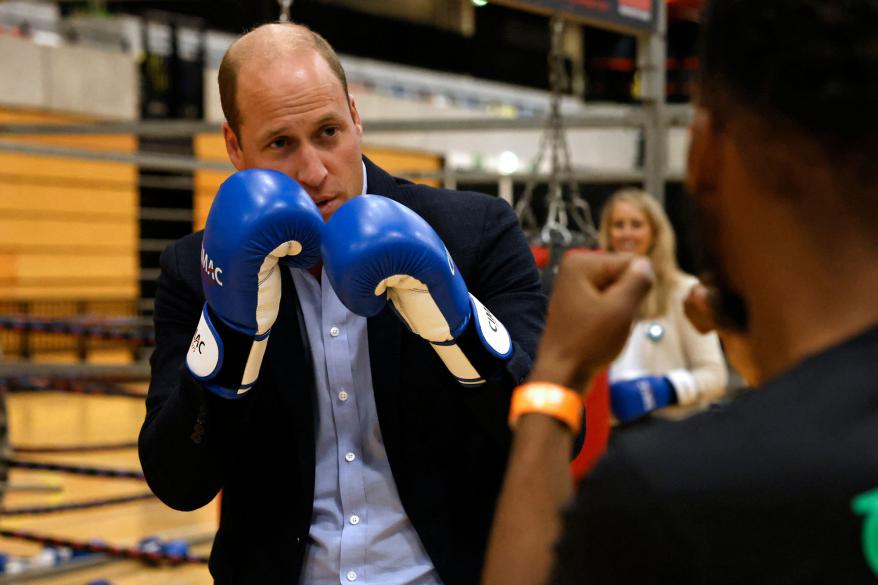 Prince William trains in boxing gloves during a visit to Copper Box Arena to celebrate the 10th anniversary of Coach Core in London on Oct. 13.