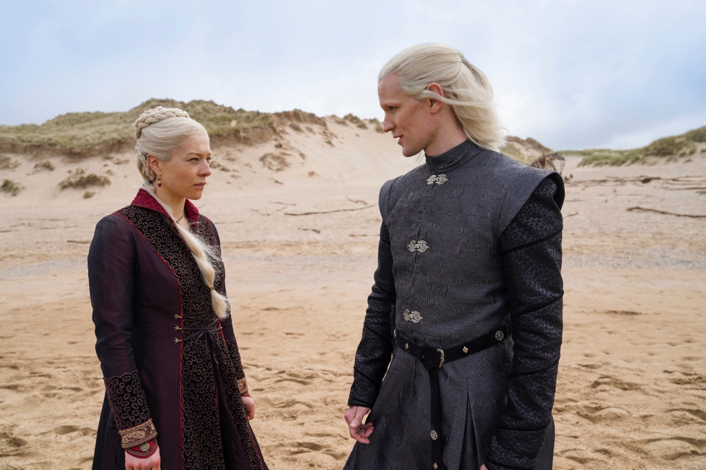 Emma D’Arcy as Princess Rhaenyra Targaryen, left, and Matt Smith as Prince Daemon Targaryen from "House of the Dragon" face each other on a beach.  