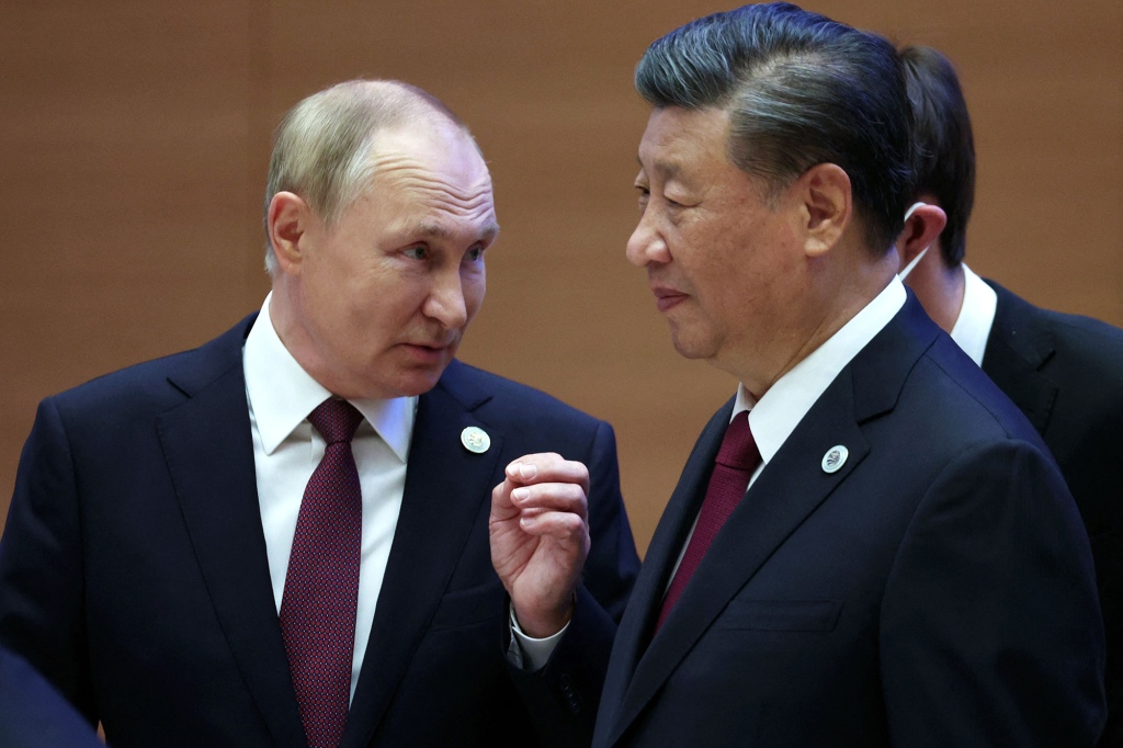 Russian President Vladimir Putin speaks to China's President Xi Jinping during the Shanghai Cooperation Organisation (SCO) leaders' summit in Samarkand on September 16.