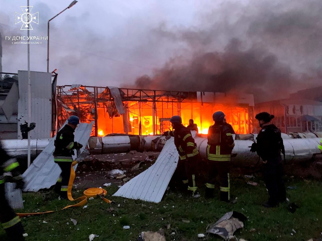 Firefighters tackle blaze at bombed-out car shop in Zaporizhzhia.