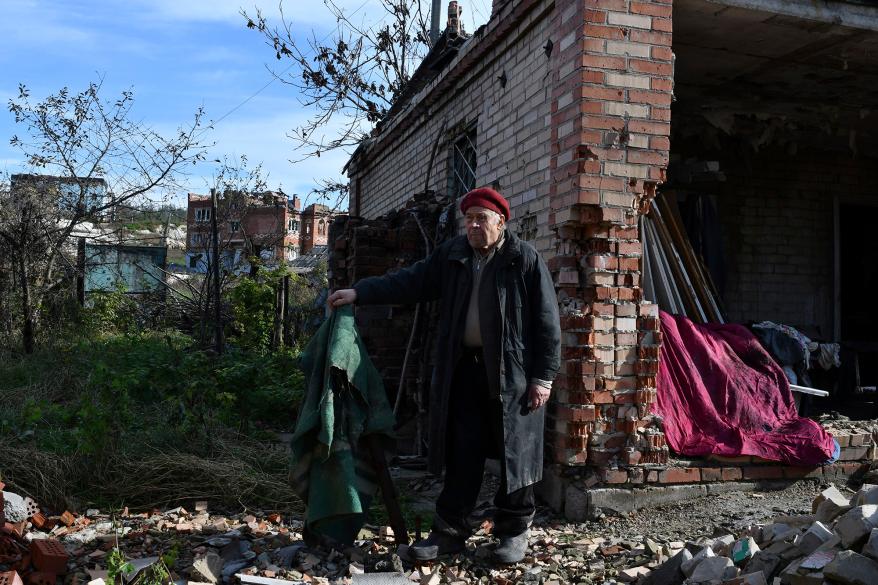 Vladimir Semenets, 84, stands in front of his damaged house in the retaken village of Bohorodychne, eastern Ukraine on October 22.