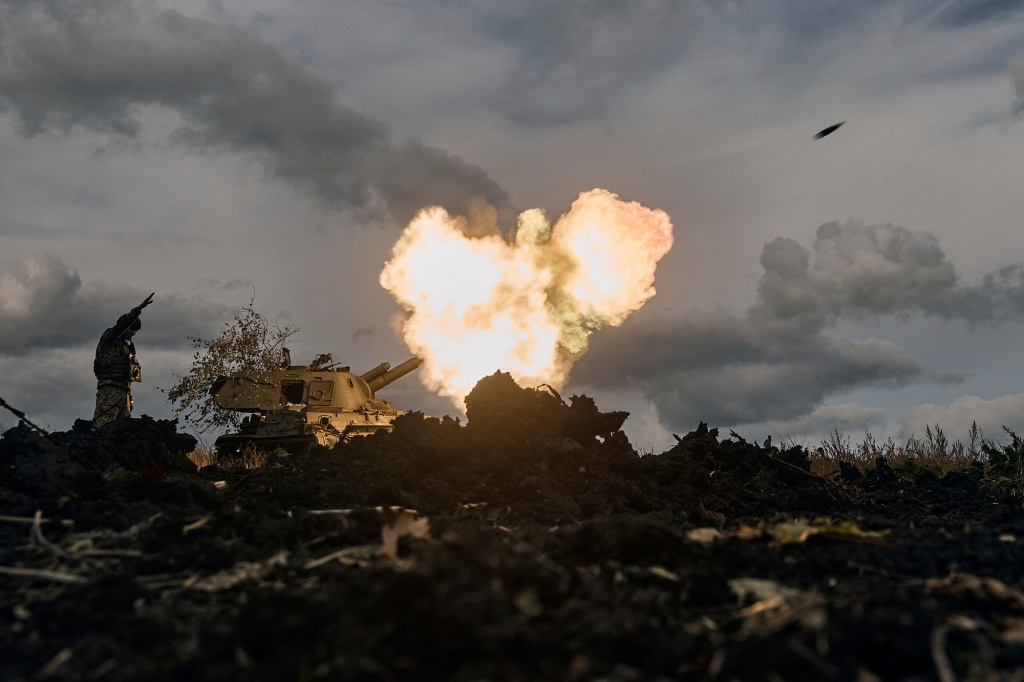 A Ukrainian serviceman reacts as a self-propelled artillery vehicle fires near Bakhmut, Donetsk region, Ukraine on October 22. 