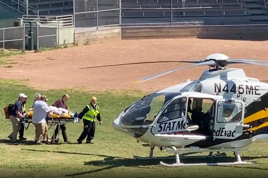author Salman Rushdie is taken on a stretcher to a helicopter for transport to a hospital