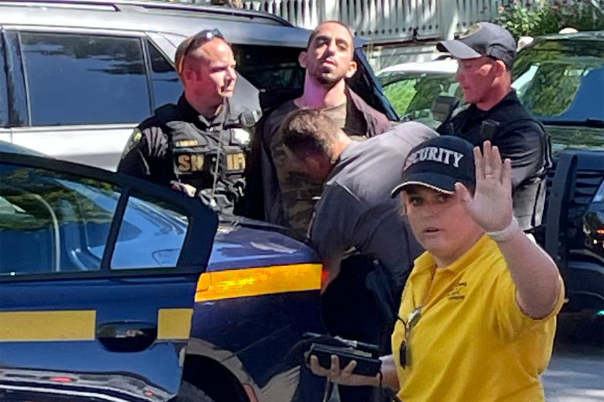 Law enforcement officers detain Hadi Matar outside of the institution in upstate New York following the attack.