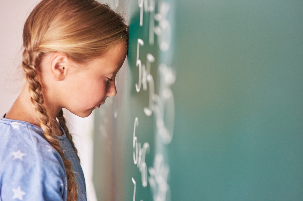 Schoolgirl trying to understand formula