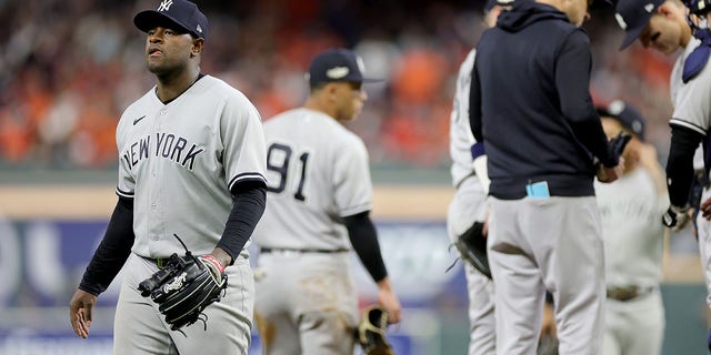 Luis Severino of the New York Yankees, left, walks off the mound after being removed during the sixth inning in Game 2 of the American League Championship Series against the Houston Astros at Minute Maid Park Oct. 20, 2022, in Houston.