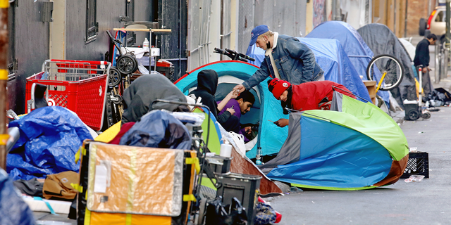 SAN FRANCISCO, CA - FEBRUARY 24: Homeless people consume illegal drugs in an encampment along Willow St. in the Tenderloin district of downtown on Thursday, Feb. 24, 2022 in San Francisco, CA. London Breed, mayor of San Francisco, is the 45th mayor of the City and County of San Francisco. She was supervisor for District 5 and was president of the Board of Supervisors from 2015 to 2018. (Gary Coronado / Los Angeles Times via Getty Images)