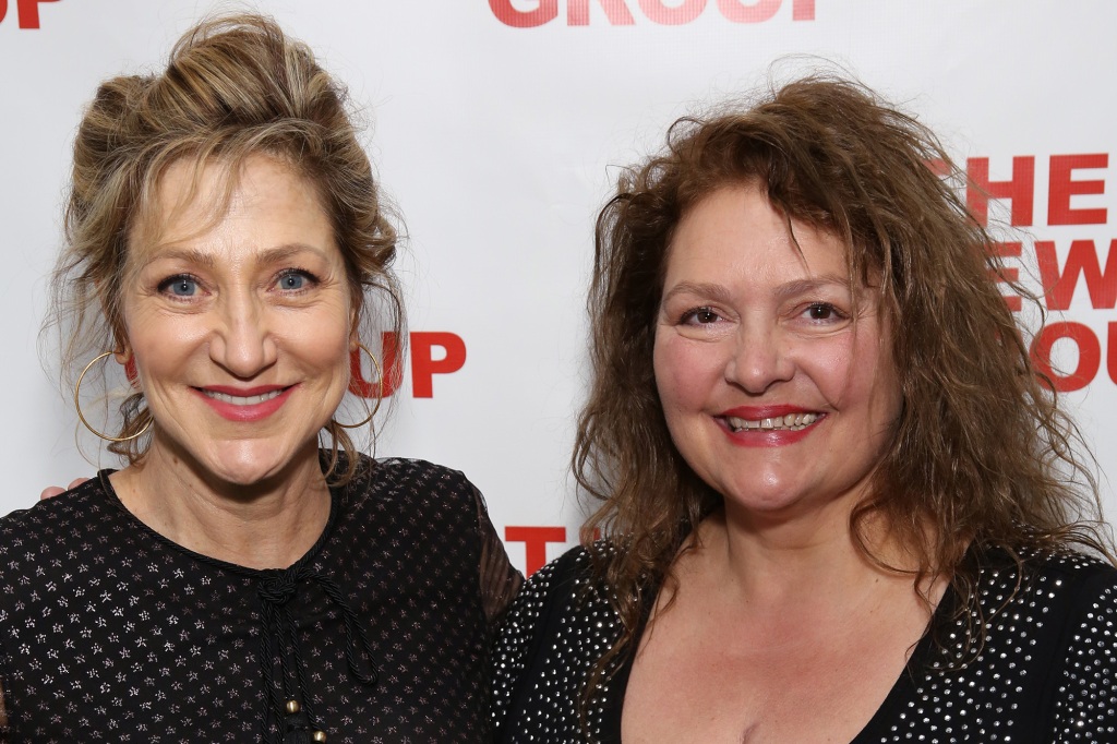 Edie Falco and Aida Turturro in a photo from 2019. They're standing closely to each other and are smiling broadly and looking directly at the camera.