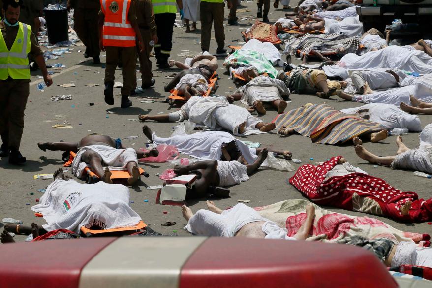 Muslim pilgrims and first responders gather around the bodies of people crushed in Mina, Saudi Arabia during the annual hajj pilgrimage on Thursday, Sept. 24, 2015.