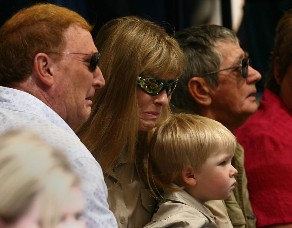 Robert is seen sitting on his mom's lap during his dad's funeral back in 2006. The youngster was just two years old when his dad died suddenly. 