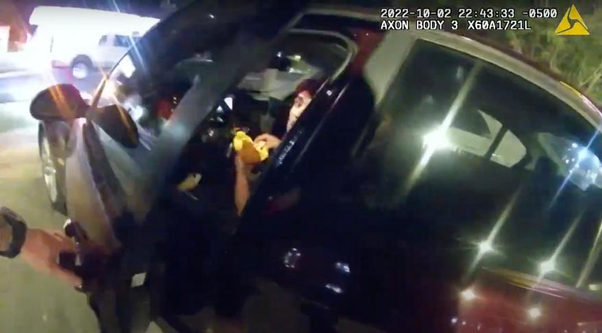 In this image taken from Oct. 2, 2022 police body camera video and released by San Antonio Police Department, Erik Cantu looks toward San Antonio Police officer James Brennand while holding a hamburger in a fast food restaurant parking lot as the officer opens the car door in San Antonio, Texas. Brennand opened fire several times wounding the unarmed teenager as he drove away. Brennand was fired after the shooting, police training commander Alyssa Campos said in a video statement released Wednesday, Oct. 5, 2022. (San Antonio Police Department via AP)