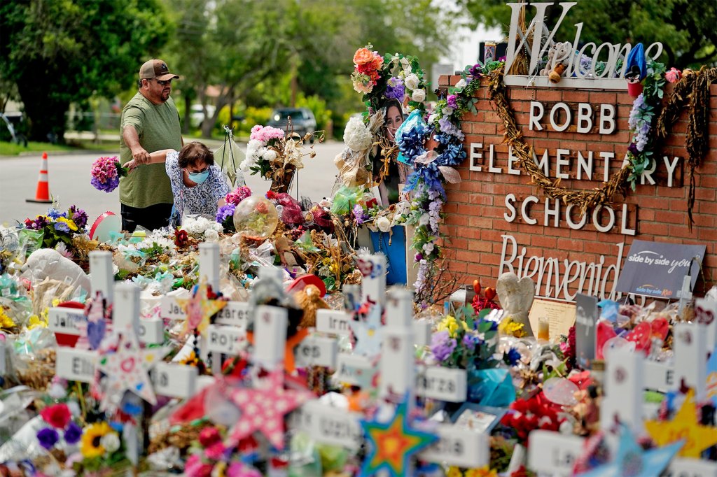 Retired teachers Raul Noyola and Ofelia Noyola visit a memorial honoring the school shooting victims at Robb Elementary on July 12, 2022 in Uvalde, Texas.