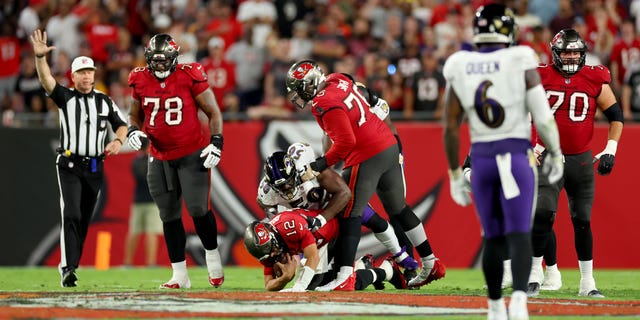 Josh Bynes #56 of the Baltimore Ravens sacks Tom Brady #12 of the Tampa Bay Buccaneers during the second quarter at Raymond James Stadium on October 27, 2022 in Tampa, Florida.