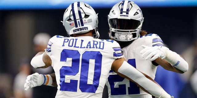 Tony Pollard and Ezekiel Elliott of the Dallas Cowboys embrace during warm-ups against the Washington Commanders, Oct. 2, 2022, in Arlington, Texas.