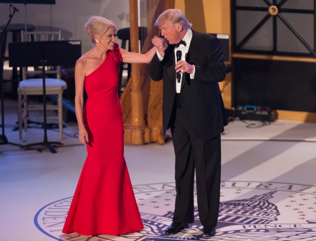Former President Donald J. Trump kisses the hand of campaign manager Kellyanne Conway at the Indiana Society Ball to thank donors January 19, 2017 in Washington, DC.