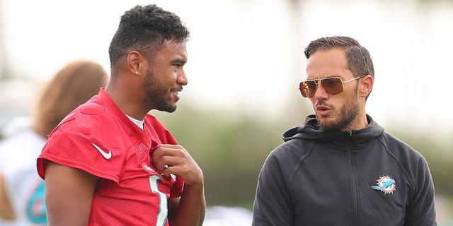 Head coach Mike McDaniel of the Miami Dolphins, right, talks with Tua Tagovailoa during training camp at Baptist Health Training Complex July 27, 2022, in Miami Gardens, Fla.