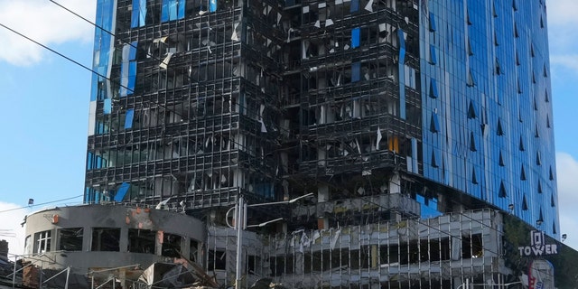 A damaged tower block at the scene of Russian shelling in Kyiv, Ukraine, Monday, Oct. 10, 2022. Two explosions rocked Kyiv early Monday following months of relative calm in the Ukrainian capital. (AP Photo/Efrem Lukatsky)