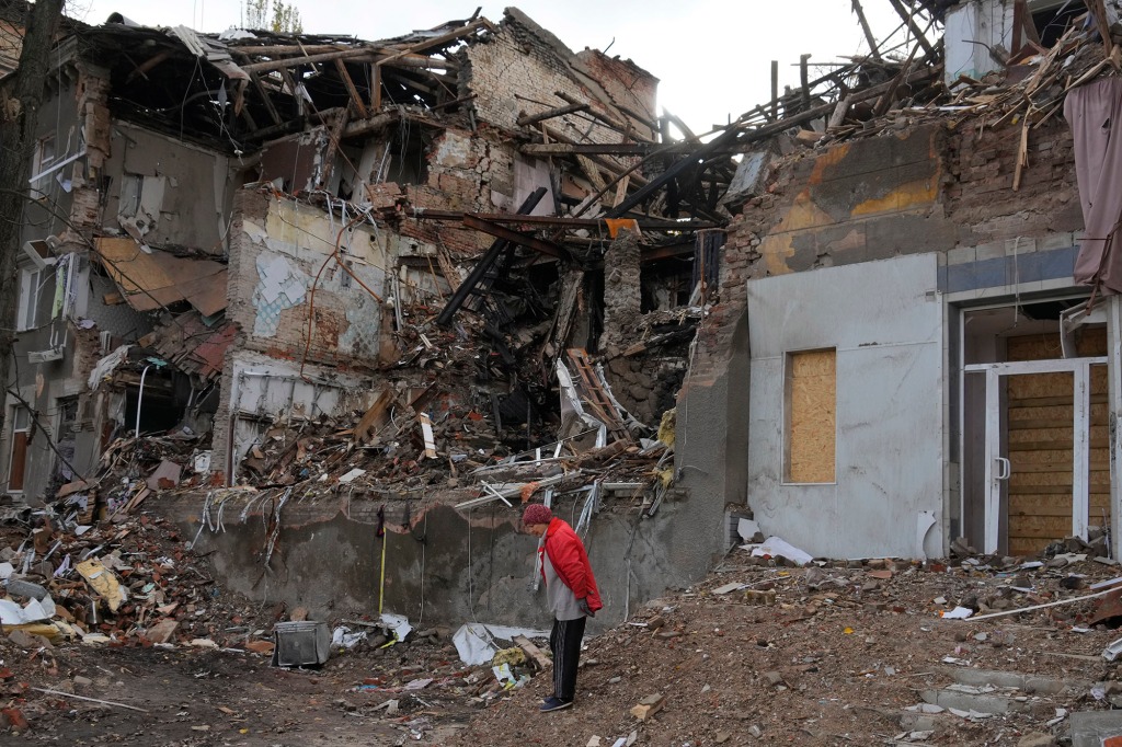 A woman stands near a house destroyed by a Russian attack in the Donetsk region of Ukraine on Oct. 29. 