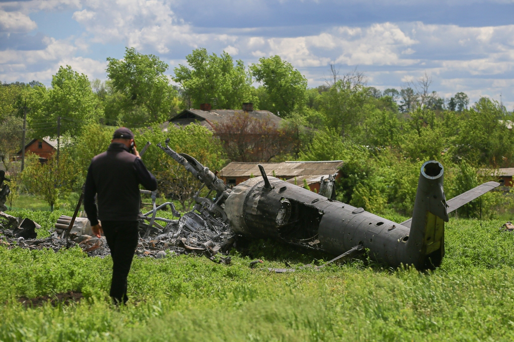 The remains of a Russian helicopter lie in a bomb-cratered field in Biskvitne, Ukraine, in May. 