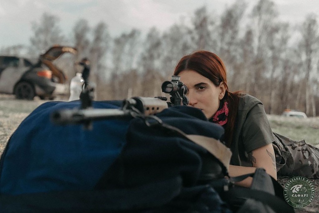 Evgenia Emerald pointing a gun