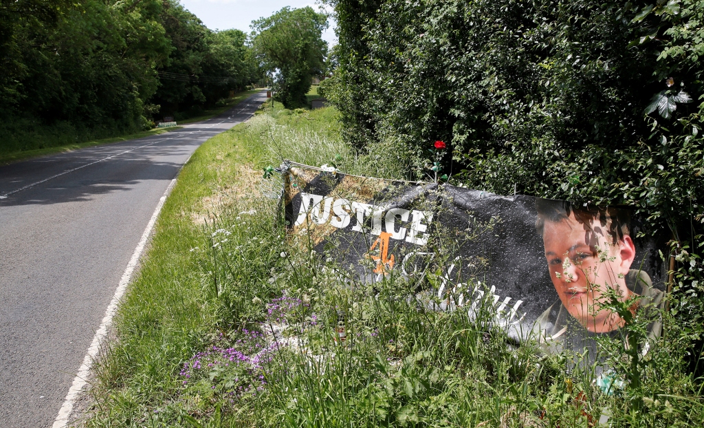 A banner and a memorial area for Harry Dunn is pictured near to the entrance of RAF Croughton.