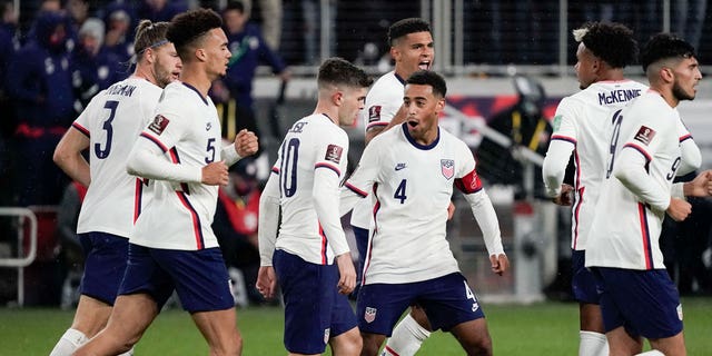 U.S. forward Christian Pulisic (10) celebrates with teammate Tyler Adams (4) after scoring a goal during the second half of a FIFA World Cup qualifying soccer match against Mexico, Friday, Nov. 12, 2021, in Cincinnati. 