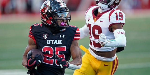 Utah wide receiver Jaylen Dixon (25) carries the ball past Southern California defensive back Jaylin Smith (19) during the first half of an NCAA college football game Saturday, Oct. 15, 2022, in Salt Lake City.