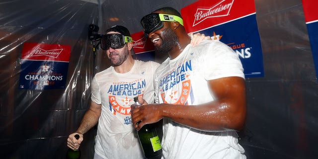 Justin Verlander, #35, and Jordan Alvarez, #44 of the Houston Astros, celebrate in the clubhouse after the Astros defeated the New York Yankees in Game 4 of the ALCS at Yankee Stadium on Sunday, Oct. 23, 2022 in New York, New York. 