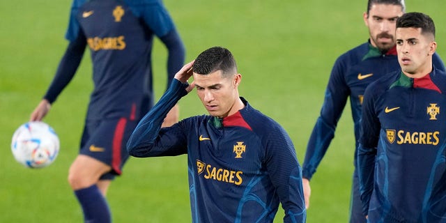 Cristiano Ronaldo, center, scratches his head during a Portugal soccer team training in Oeiras, outside Lisbon, on Monday.